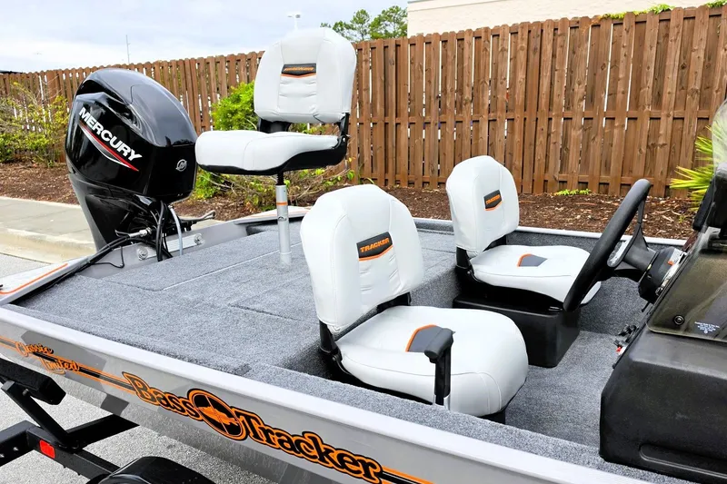 Slide: The Image of 2027 Tracker Bass Tracker Classic Limited boat with Mercury engine, featuring white seating and sleek design. - 13