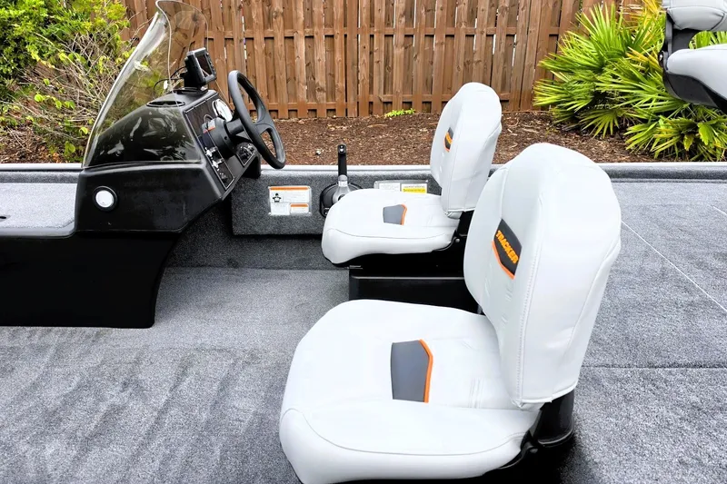 Slide: The Image of 2027 Tracker Bass Tracker Classic Limited boat interior with white seats and steering console. - 14