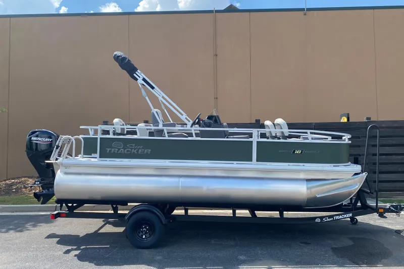 The Image of 2027 Sun Tracker Bass Buggy 18 DLX pontoon boat on trailer, side view. - 0