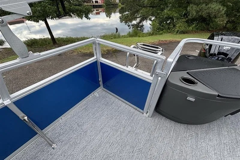 Slide: The Image of 2027 Sun Tracker Bass Buggy 18 DLX pontoon boat deck with railing and storage. - 21