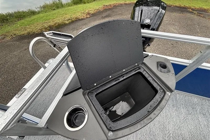 Slide: The Image of 2027 Sun Tracker Bass Buggy 18 DLX boat with open storage compartment and cup holder. - 19