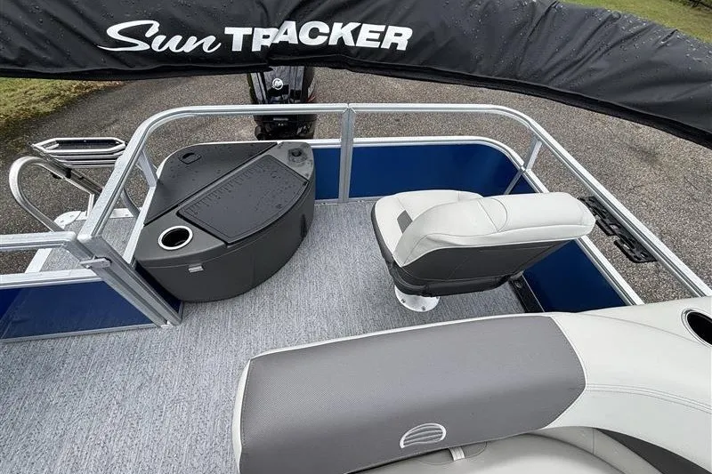Slide: The Image of 2027 Sun Tracker Bass Buggy 18 DLX pontoon boat interior with seating and storage. - 18