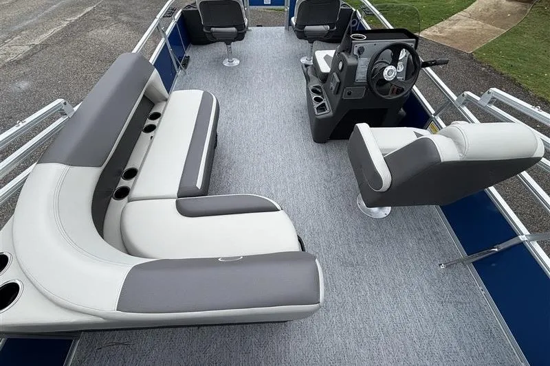 Slide: The Image of 2027 Sun Tracker Bass Buggy 18 DLX pontoon boat interior with seating and steering console. - 17