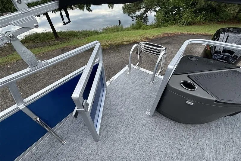 Slide: The Image of 2027 Sun Tracker Bass Buggy 18 DLX pontoon boat with open gate and ladder. - 20