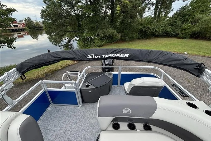 Slide: The Image of 2027 Sun Tracker Bass Buggy 18 DLX pontoon boat interior with seating and canopy. - 22
