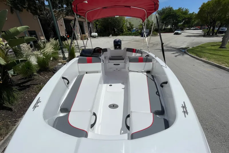 Slide: The Image of 2027 Tahoe T18 boat with red canopy, spacious seating, and sleek design in a sunny outdoor setting. - 3