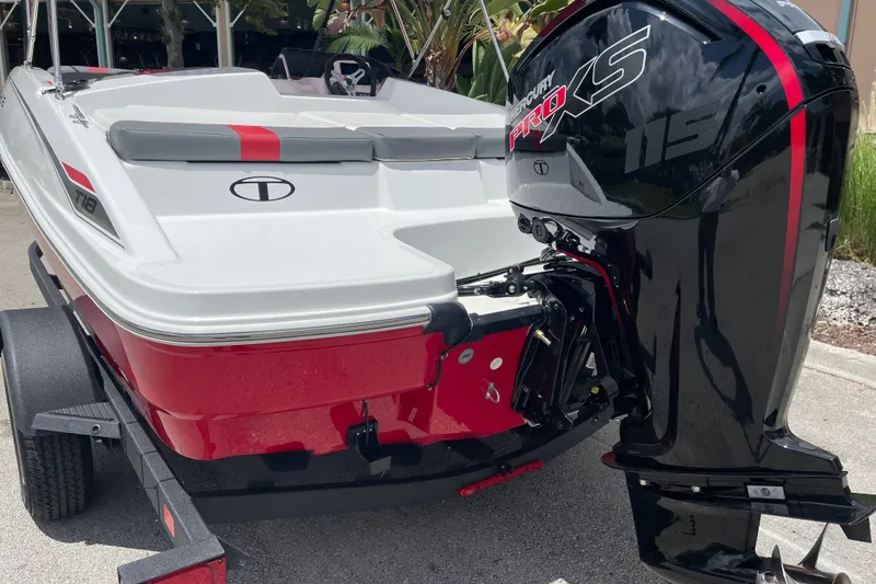 Slide: The Image of 2027 Tahoe T18 boat with Mercury Pro XS 115 outboard motor, parked on trailer. - 2
