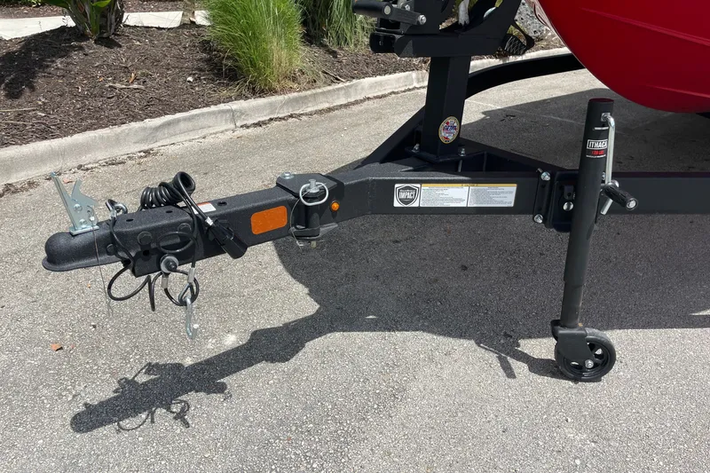 Slide: The Image of Trailer hitch of a 2027 Tahoe T18 boat on a paved surface. - 4