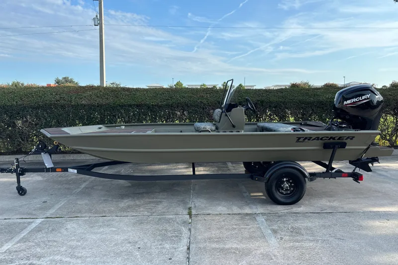 The Image of 2027 Tracker Grizzly 1860 CC boat on trailer, parked outdoors. - 0