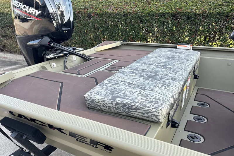 Slide: The Image of 2027 Tracker Grizzly 1860 CC boat interior with Mercury engine and camo seating. - 15