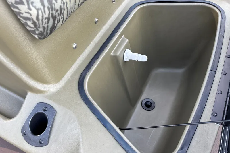 Slide: The Image of 2027 Tracker Grizzly 1860 CC boat interior with storage compartment and rod holder. - 17