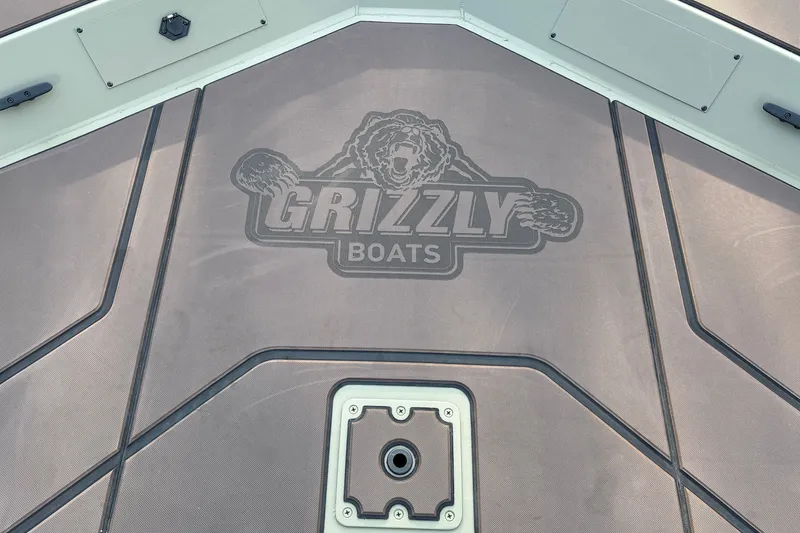 Slide: The Image of 2027 Tracker Grizzly 1860 CC boat deck with Grizzly Boats logo. - 14
