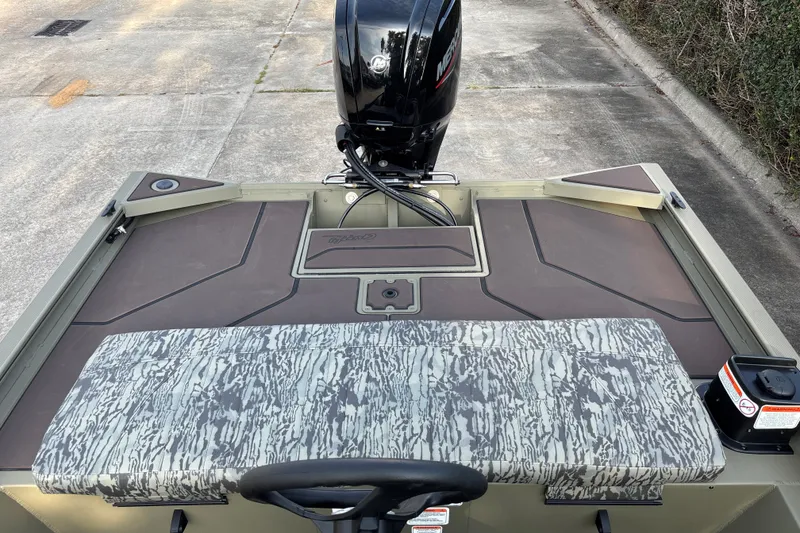 Slide: The Image of 2027 Tracker Grizzly 1860 CC boat with camo seating and Mercury outboard motor. - 16