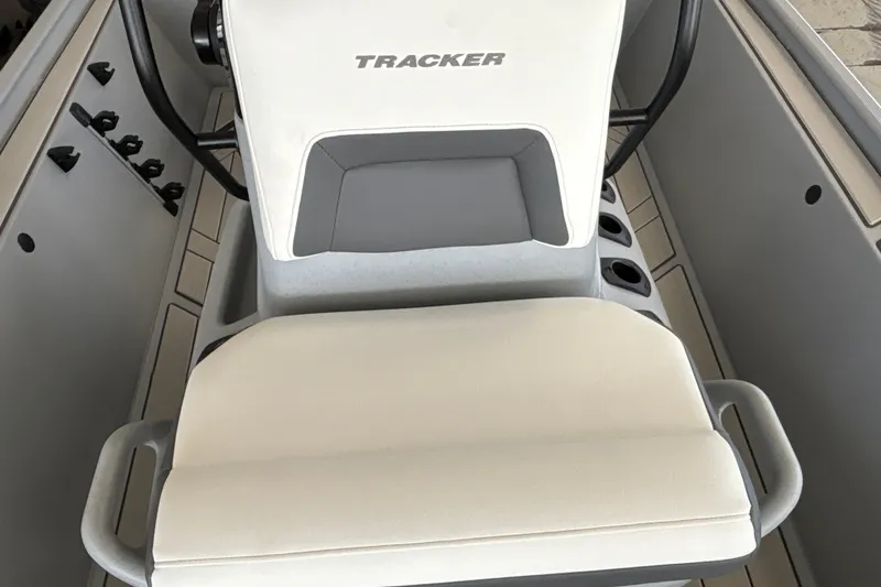 Slide: The Image of 2027 Tracker Bass Tracker Classic CC boat interior with cushioned seating and control panel. - 24