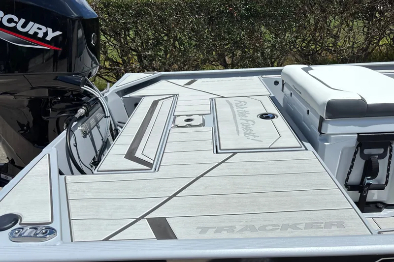 Slide: The Image of 2027 Tracker Bass Tracker Classic CC boat deck with Mercury engine, featuring sleek design. - 14