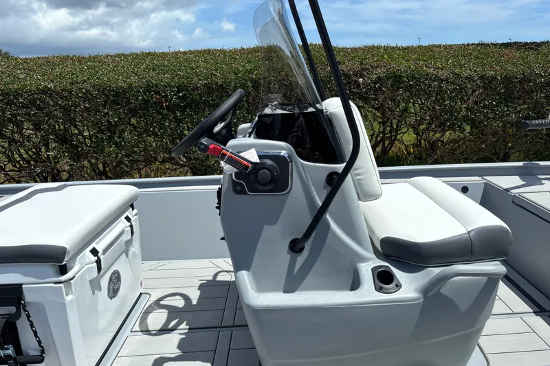 Slide: The Image of 2027 Tracker Bass Tracker Classic CC boat console with steering wheel and seating. - 13