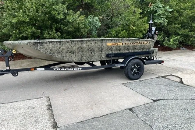 The Image of 2027 Tracker Grizzly 1553 Timber boat on trailer, parked outdoors. - 0