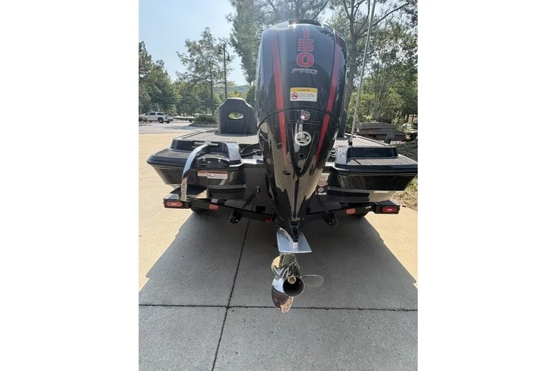 Slide: The Image of 2027 Nitro Z18 XL Pro boat with powerful 150 HP engine, parked outdoors. - 2