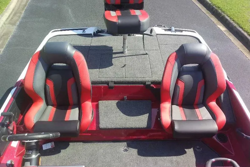 Slide: The Image of 2027 Nitro Z18 XL boat interior with red and black seats on a sunny day. - 6