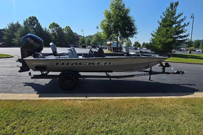 The Image of 2027 Tracker Pro Team 190 boat on trailer, parked outdoors in a sunny setting. - 0