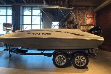 The Image of 2027 Tahoe 1950 boat on trailer in showroom, side view. - 0