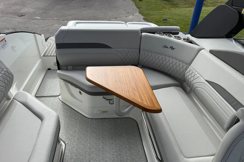 Slide: The Image of Luxurious seating area on 2027 Sea Ray SLX 260 boat with wooden table. - 18