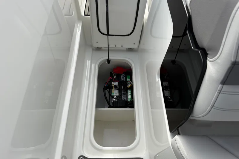 Slide: The Image of Battery compartment of 2027 Sea Ray SLX 260 boat, showcasing storage design. - 22