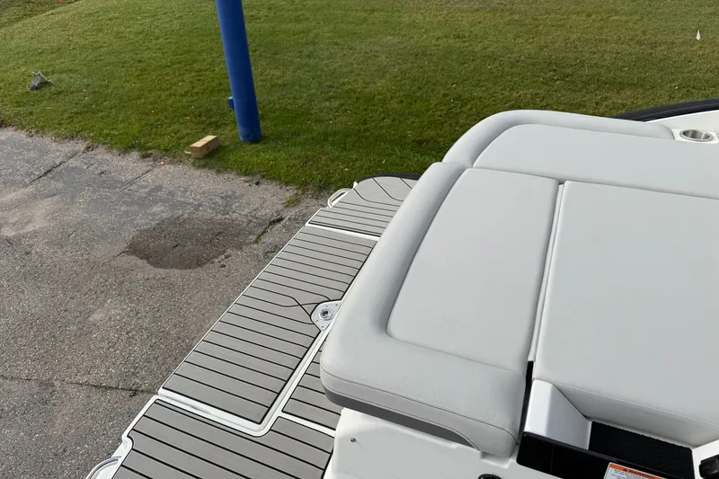 Slide: The Image of 2027 Sea Ray SLX 260 boat deck with cushioned seating and sleek design. - 24