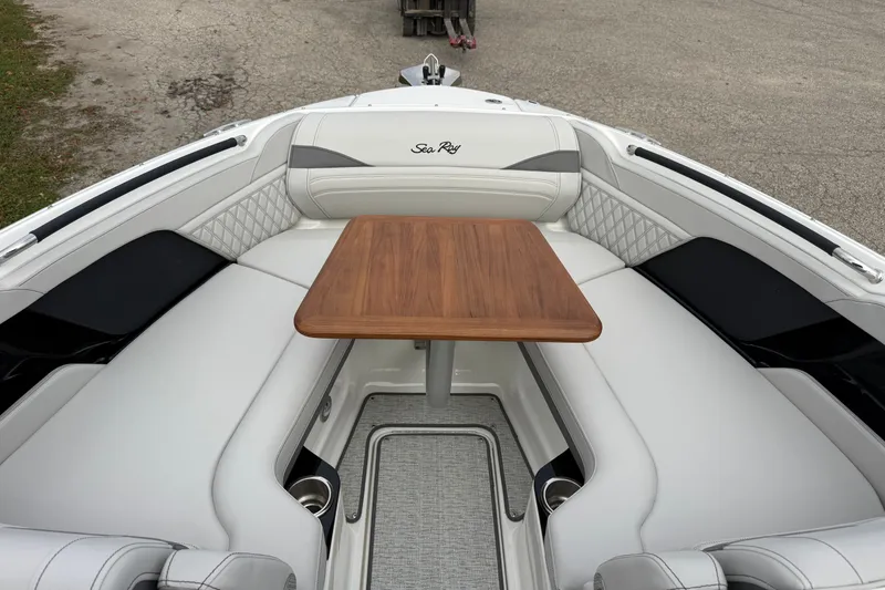 Slide: The Image of 2027 Sea Ray SLX 260 boat interior with elegant seating and wooden table. - 17