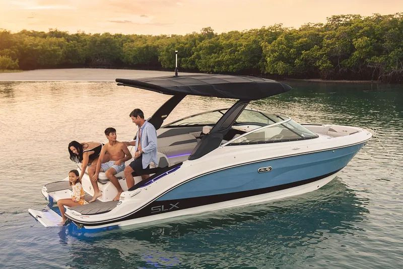 Slide: The Image of Manufacturer Provided Image: Family enjoying a 2025 Sea Ray SLX 260 boat on serene water. - 2
