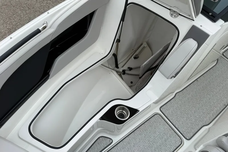 Slide: The Image of Storage compartment of 2027 Sea Ray SLX 260 boat, featuring sleek design and cup holder. - 15
