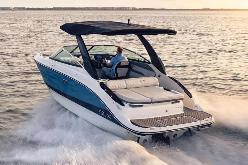 Slide: The Image of Manufacturer Provided Image: 2025 Sea Ray SLX 260 cruising on open water at sunset. - 1