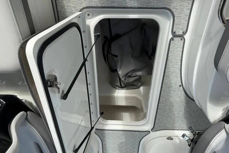 Slide: The Image of Open storage compartment on 2027 Sea Ray SLX 260 boat interior. - 21