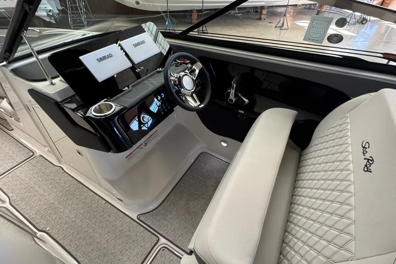 Slide: The Image of 2027 Sea Ray SLX 280 helm with dual Simrad displays and luxurious seating. - 15