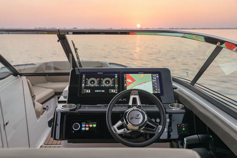 Slide: The Image of Manufacturer Provided Image: 2025 Sea Ray SLX 280 dashboard with navigation screens at sunset on the water. - 5