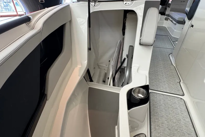 Slide: The Image of Interior storage compartment of 2027 Sea Ray SLX 280 boat, featuring sleek design and cup holder. - 19