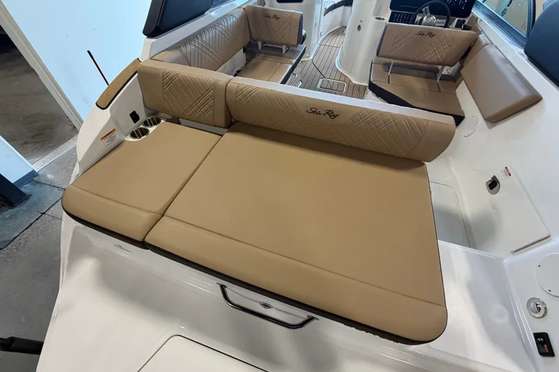 Slide: The Image of Interior of 2027 Sea Ray SDX 230 boat with tan cushioned seating. - 17