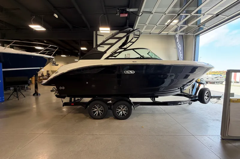 The Image of 2027 Sea Ray SDX 230 boat on trailer in showroom, side view. - 1