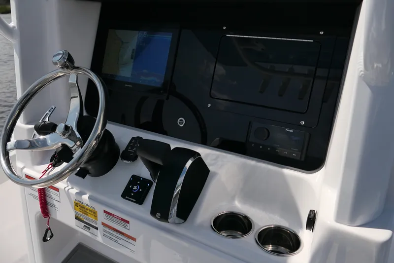 Slide: The Image of Helm of 2027 Blackfin 242 HB boat with steering wheel and navigation controls. - 30