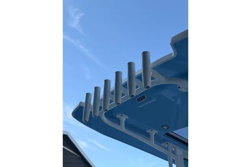 Slide: The Image of Rooftop rod holders on 2027 Blackfin 242 HB boat against clear blue sky. - 44