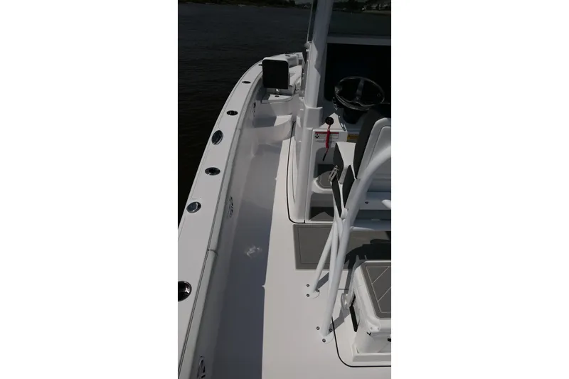 Slide: The Image of 2027 Blackfin 242 HB boat deck with steering console and seating area. - 36