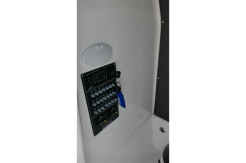 Slide: The Image of Control panel of 2027 Blackfin 242 HB boat with keys and switches. - 50
