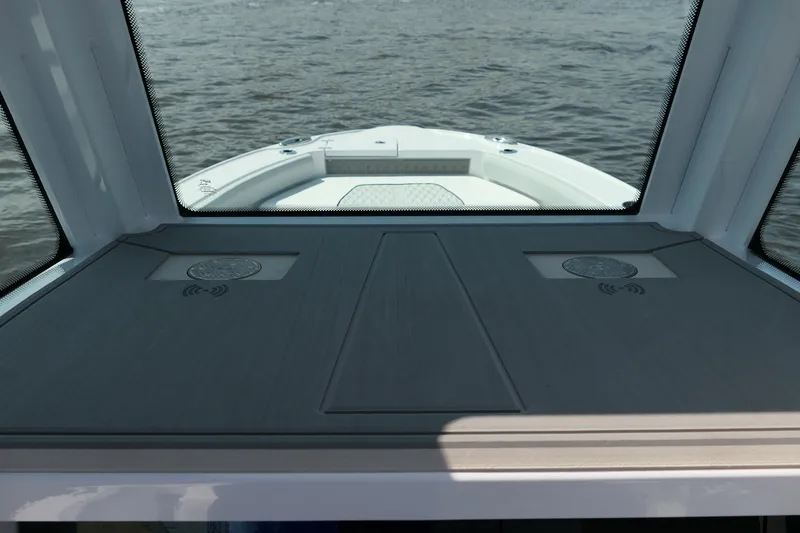 Slide: The Image of Interior view of 2027 Blackfin 242 HB boat, showcasing sleek design and water backdrop. - 28