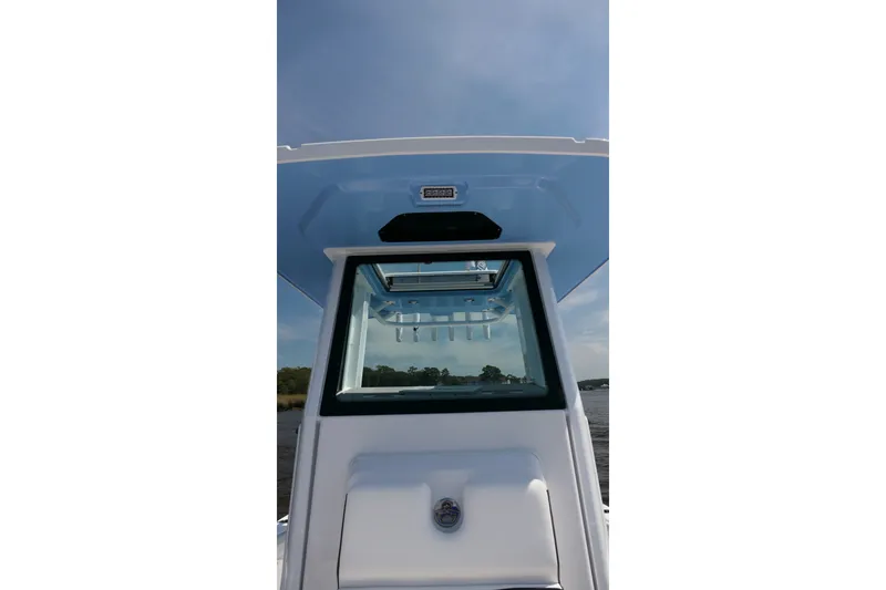 Slide: The Image of 2027 Blackfin 242 HB boat console with clear windshield and blue sky background. - 14