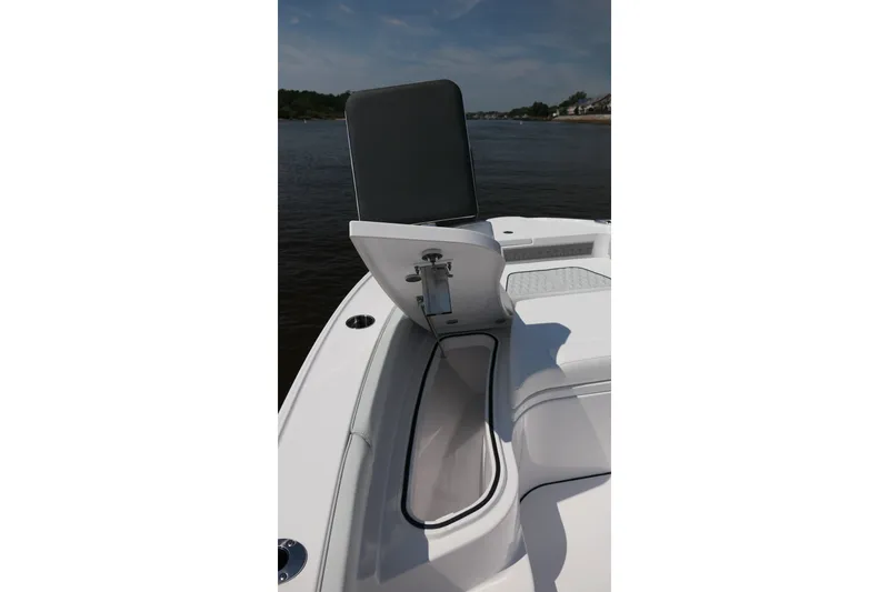 Slide: The Image of 2027 Blackfin 242 HB boat with open storage compartment on deck, near calm waters. - 24