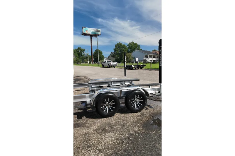 Slide: The Image of Trailer for 2027 Blackfin 242 HB boat parked on a sunny day. - 54