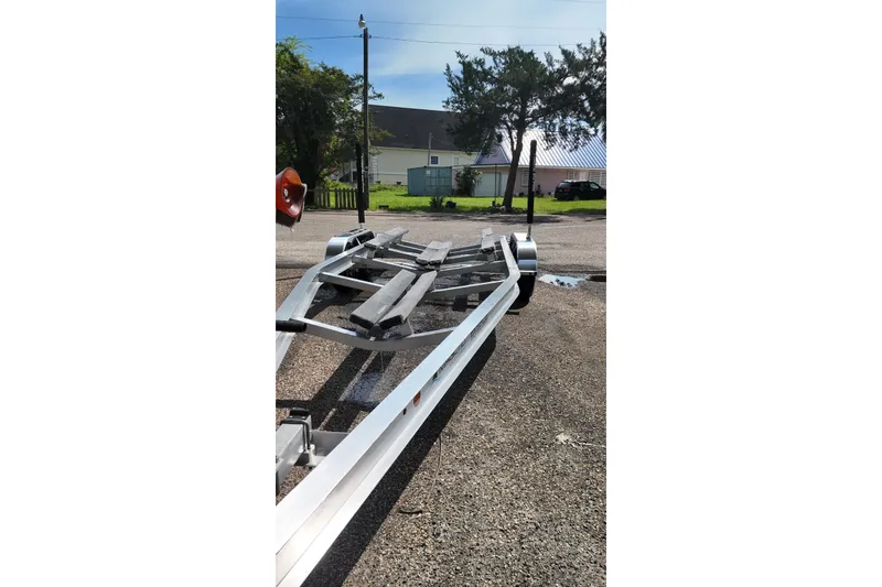 Slide: The Image of Boat trailer on pavement, Blackfin 242 HB, 2027 model, sunny day, residential background. - 52
