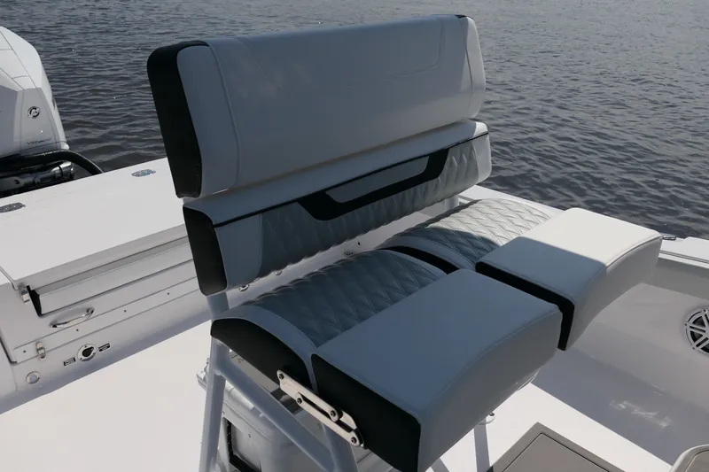 Slide: The Image of 2027 Blackfin 242 HB boat seating with quilted upholstery, on calm water. - 17