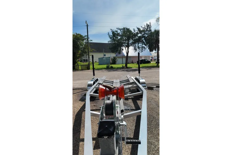 Slide: The Image of Boat trailer for 2027 Blackfin 242 HB, parked outdoors on a sunny day. - 53