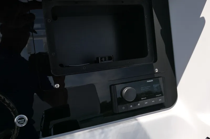 Slide: The Image of Control panel of 2027 Blackfin 242 HB boat with Fusion audio system. - 35